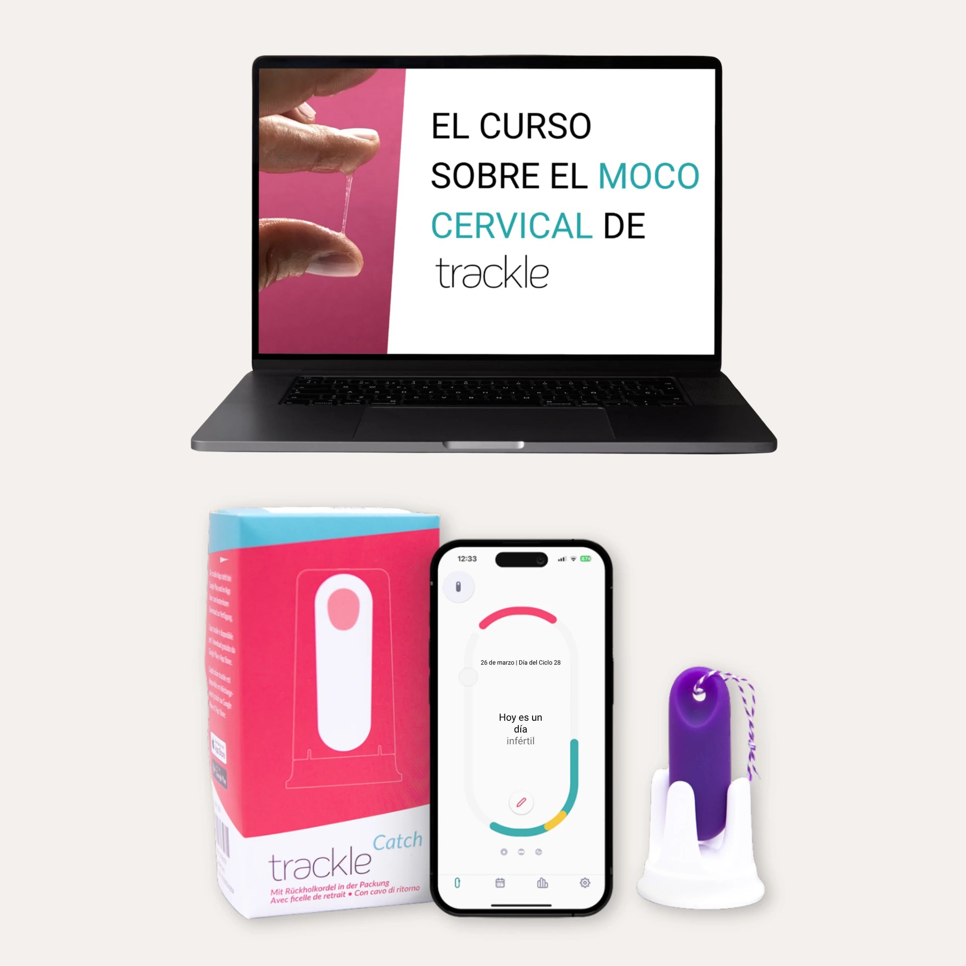 El trackle kit de inicio para principiantes: un ordenador portátil muestra el curso digital sobre el moco cervical de trackle. Debajo se ve el envase rosa y azul de trackleCatch, un smartphone con la aplicación trackle abierta (que muestra un día infértil) y el trackleCatch morado en su soporte blanco.